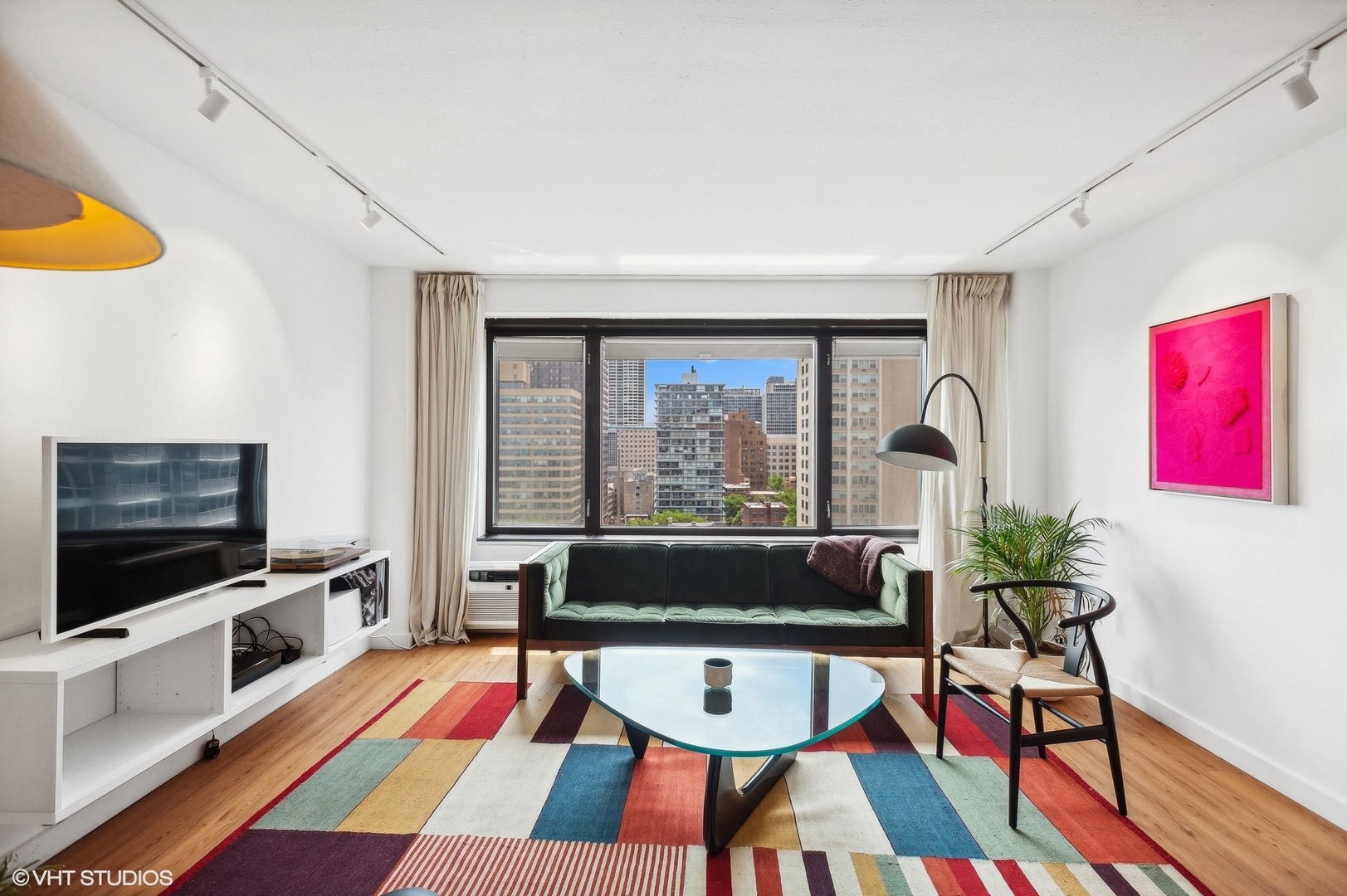 3100 North Lake Shore Drive, Unit 1404 Chicago, IL 60657 - Photo 3 of 15 a living room with patio furniture and a flat screen tv