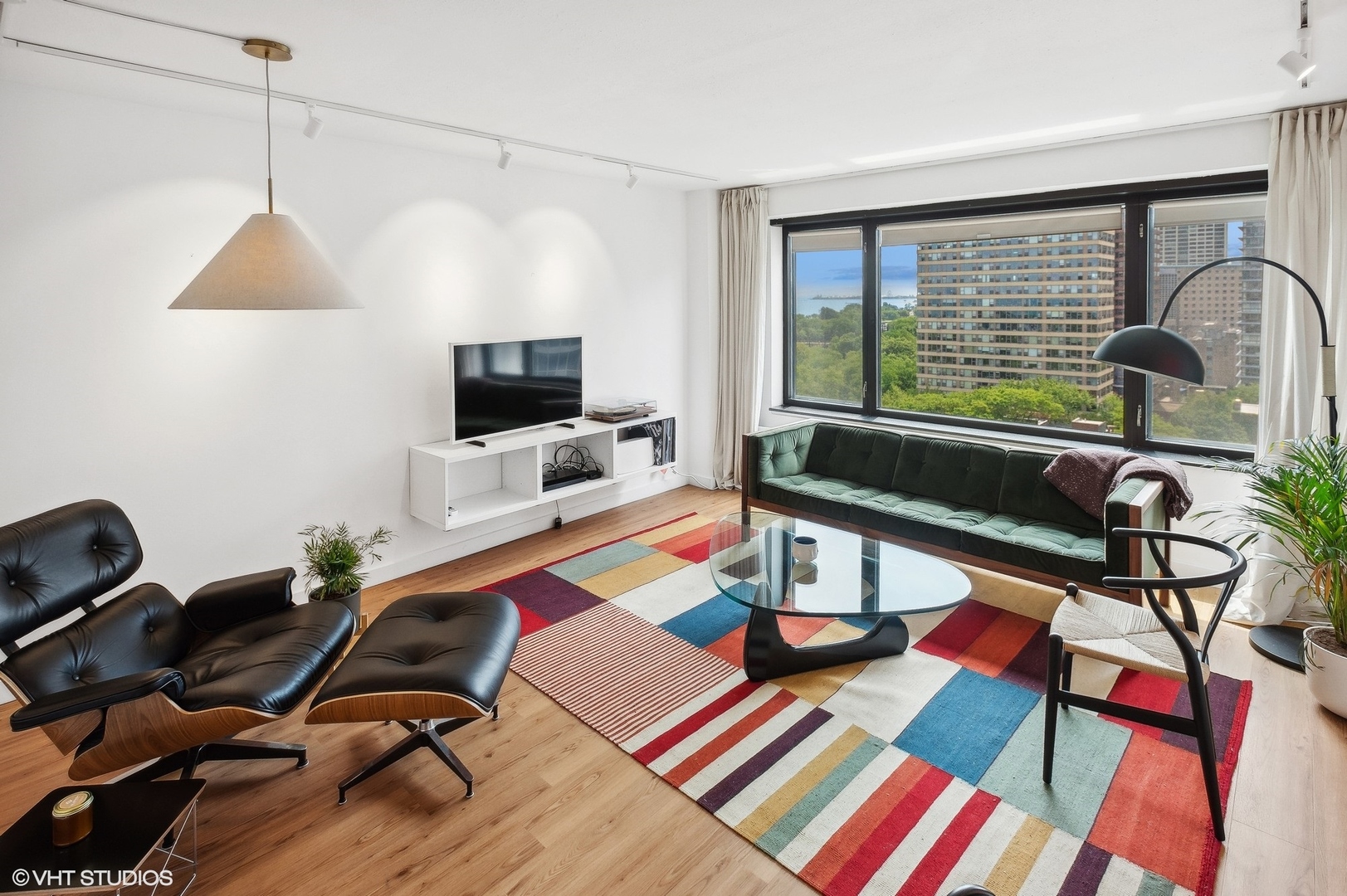 3100 North Lake Shore Drive, Unit 1404 Chicago, IL 60657 - Photo 4 of 15 a work room with furniture and a flat screen tv