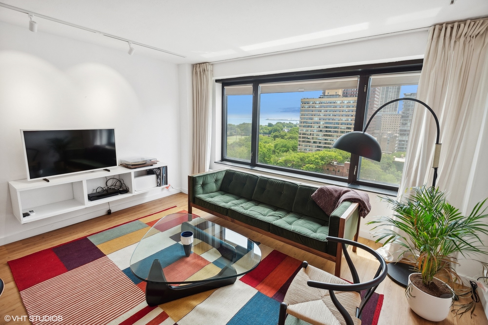 3100 North Lake Shore Drive, Unit 1404 Chicago, IL 60657 - Photo 5 of 15 a living room with furniture and a flat screen tv