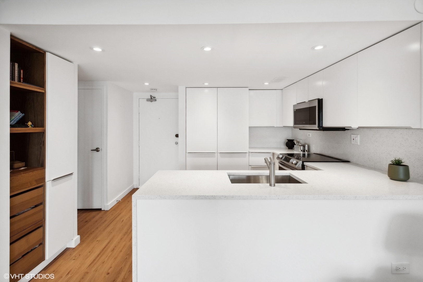3100 North Lake Shore Drive, Unit 1404 Chicago, IL 60657 - Photo 7 of 15 a kitchen with sink a refrigerator and cabinets