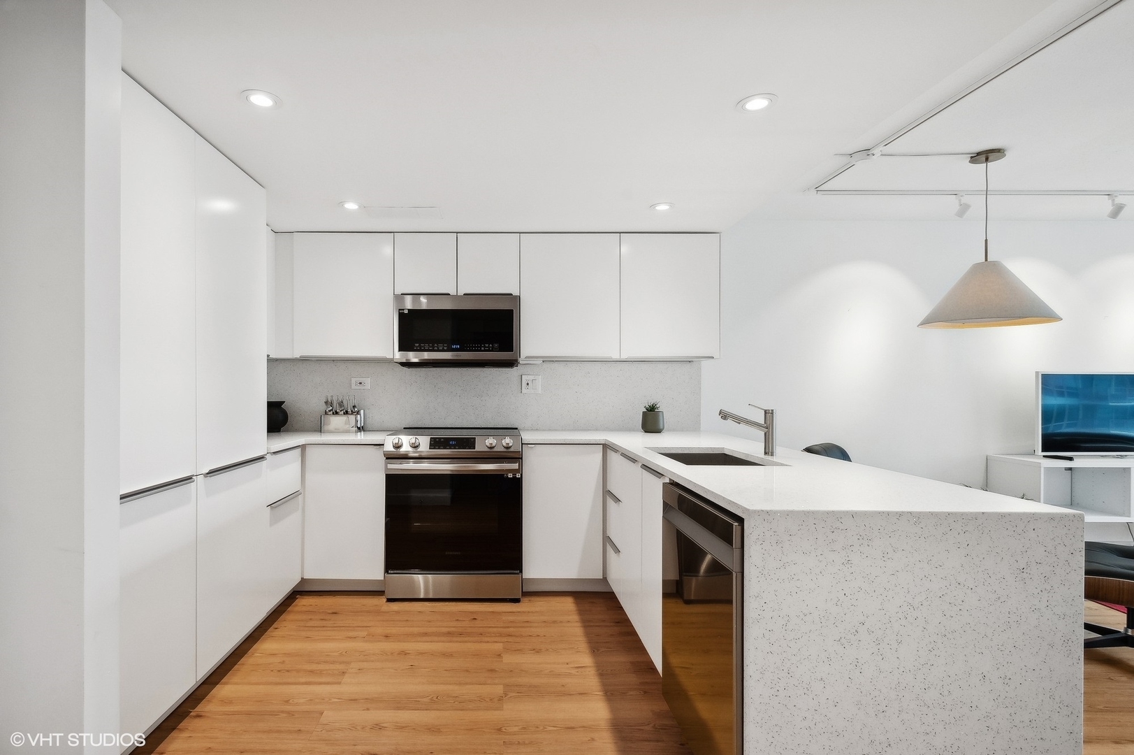 3100 North Lake Shore Drive, Unit 1404 Chicago, IL 60657 - Photo 8 of 15 a kitchen with stainless steel appliances granite countertop a sink a stove a microwave and a refrigerator