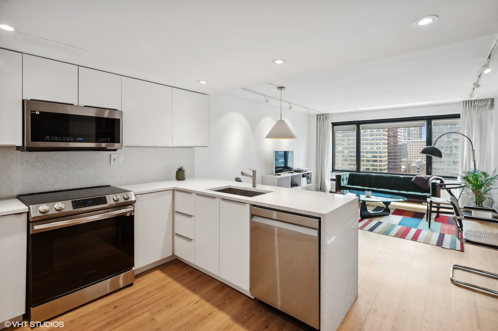 3100 North Lake Shore Drive, Unit 1404 Chicago, IL 60657 - Photo 9 of 15 a kitchen with a stove a sink and a microwave