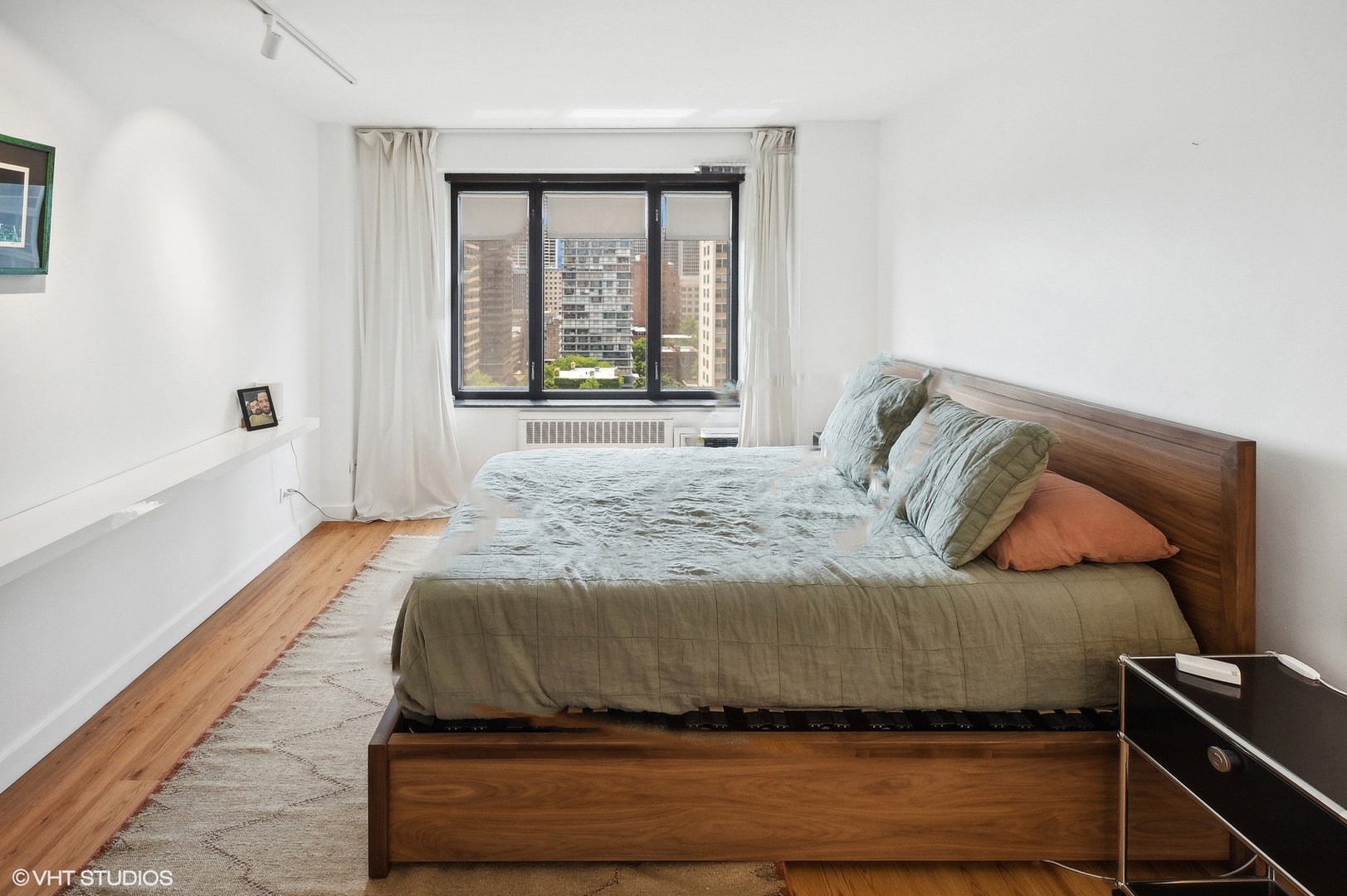 3100 North Lake Shore Drive, Unit 1404 Chicago, IL 60657 - Photo 10 of 15 a bedroom with a bed and a window