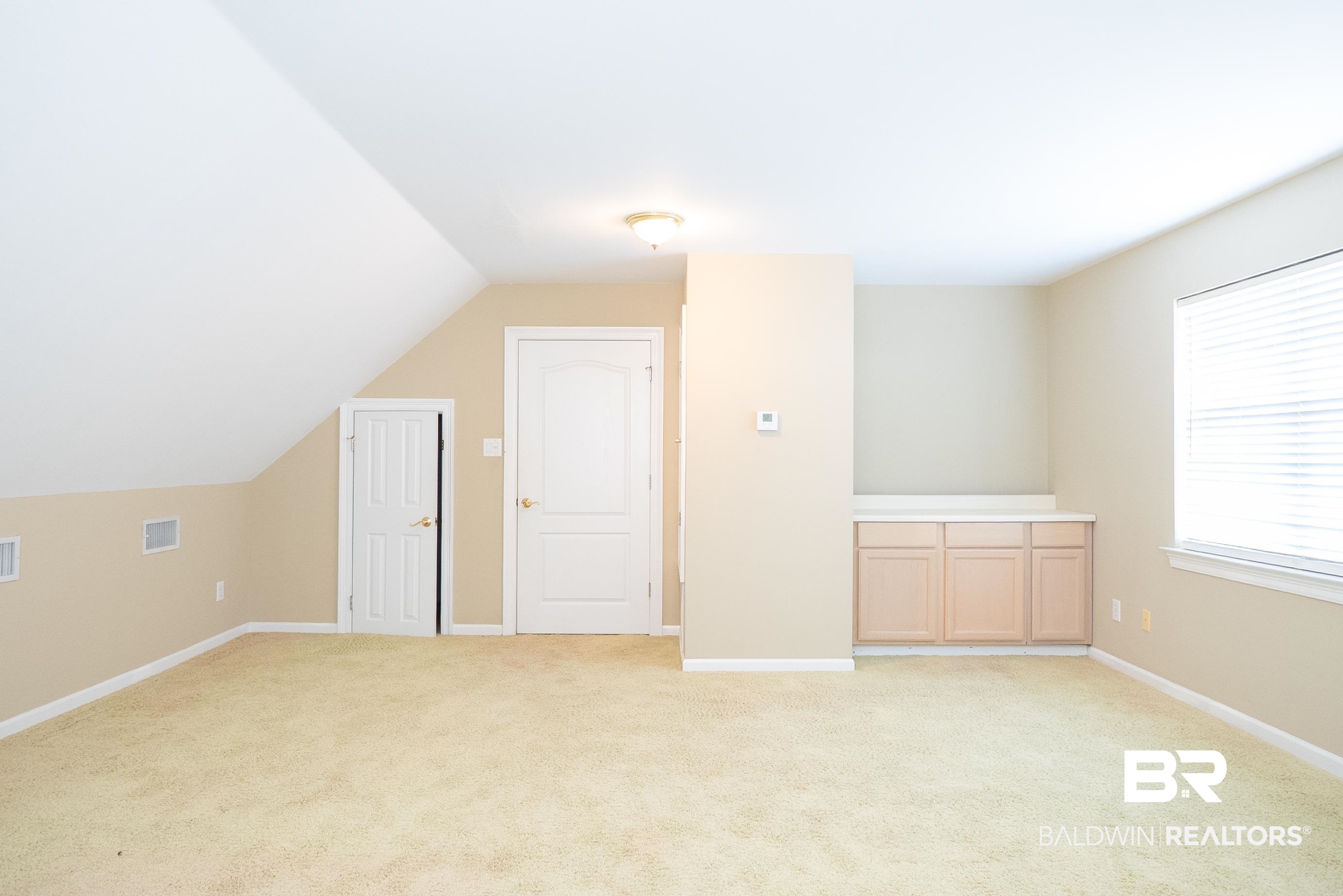 10023 Springfield Court Mobile, AL 36695 - Photo 41 of 50 Bonus room featuring light colored carpet and vaulted ceiling