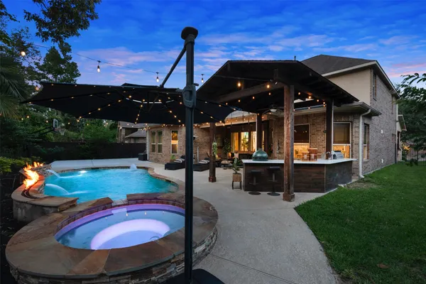 a view of a backyard with furniture and a garden