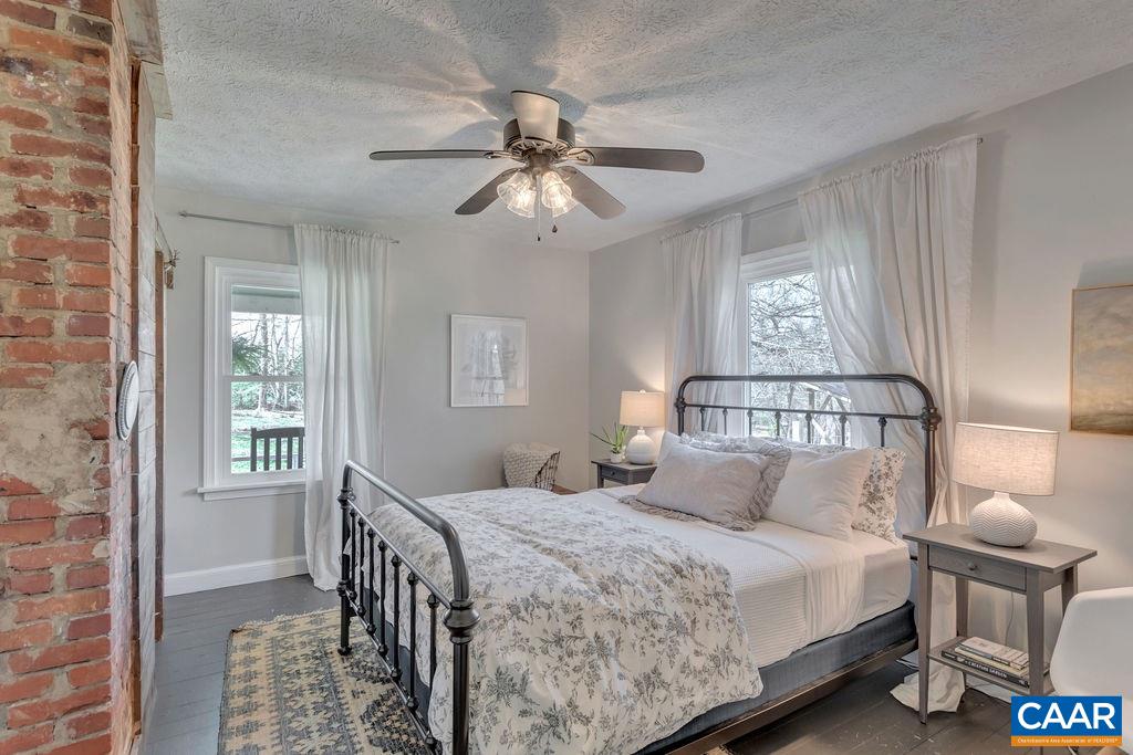 923 Smith Road Afton, VA 22920 - Photo 12 of 34 a bedroom with a bed and a chandelier