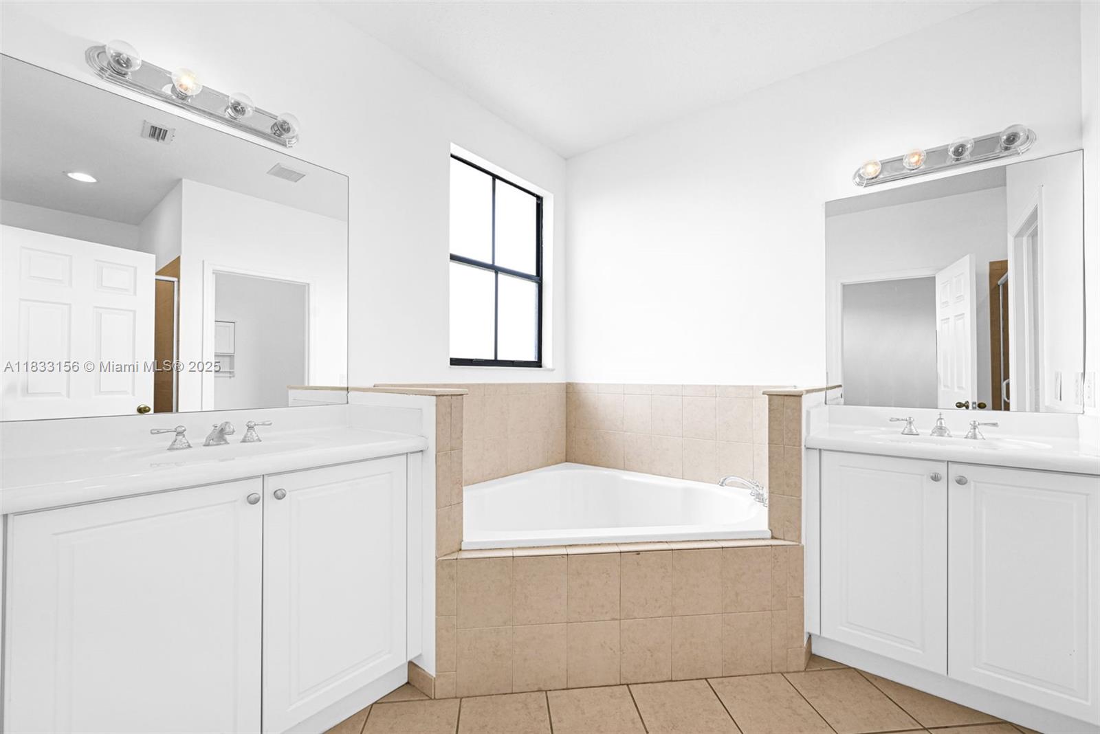 Doral Doral, FL 33172 - Photo 46 of 63 a bathroom with a tub sink and mirror