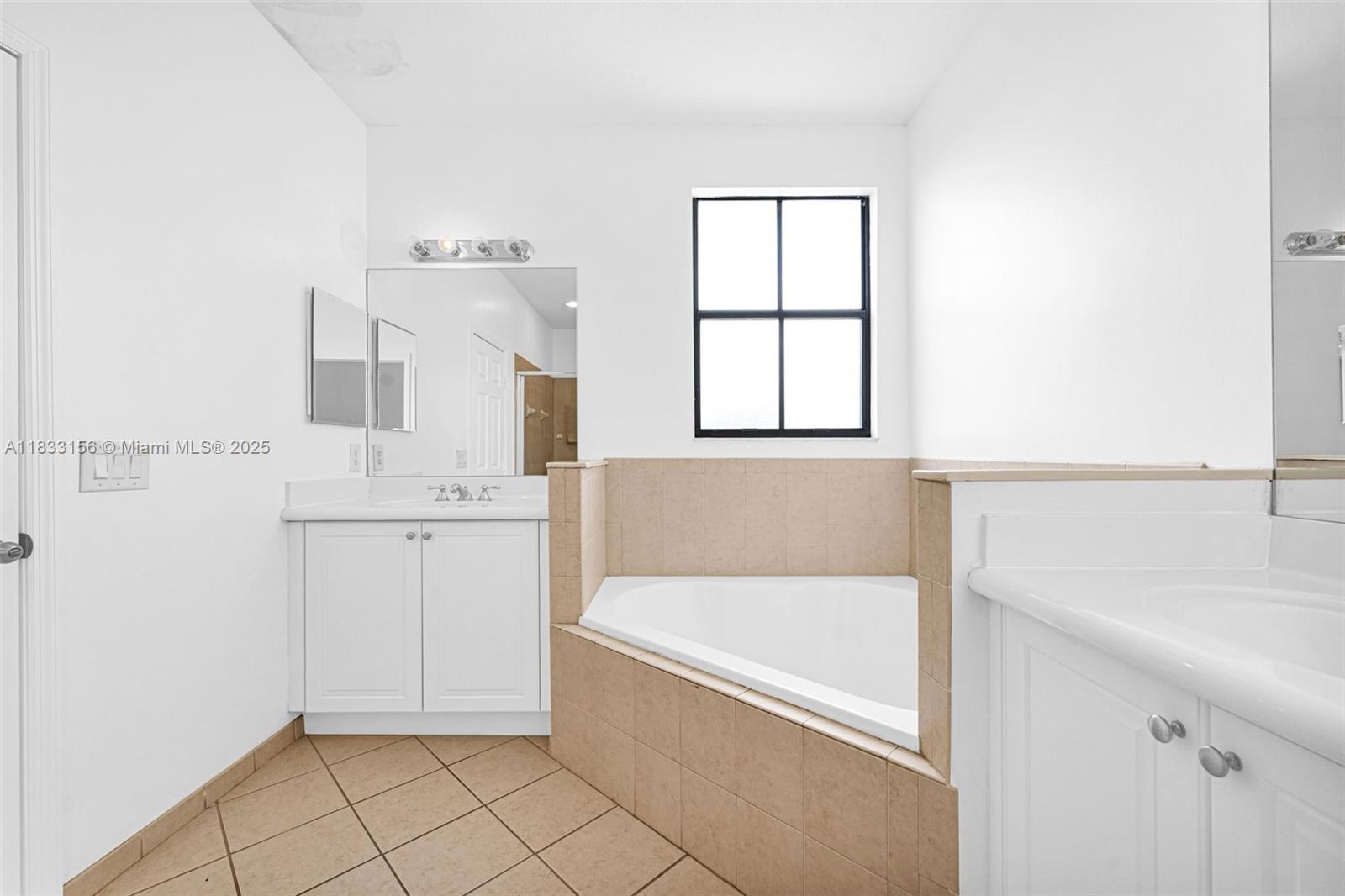 Doral Doral, FL 33172 - Photo 48 of 63 a bathroom with a bathtub sink and mirror