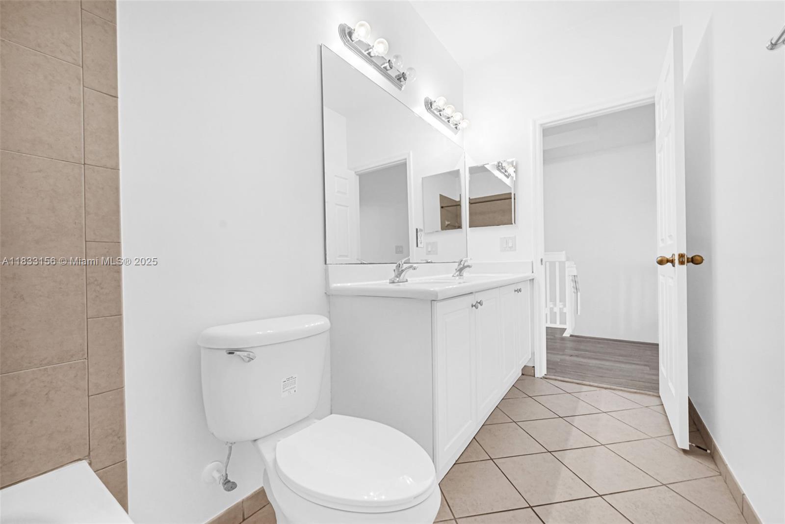 Doral Doral, FL 33172 - Photo 61 of 63 a bathroom with a sink a toilet and mirror