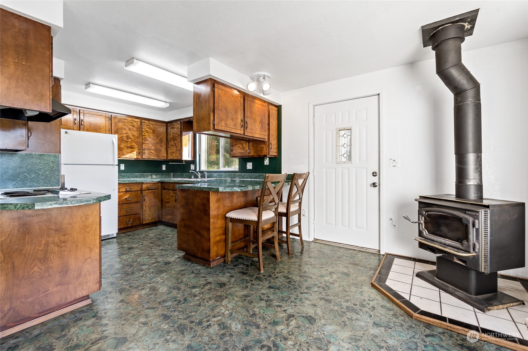 481 Arrowhead Drive Elma, WA 98541 - Photo 13 of 32 a kitchen with kitchen island granite countertop a stove a sink a table and chairs