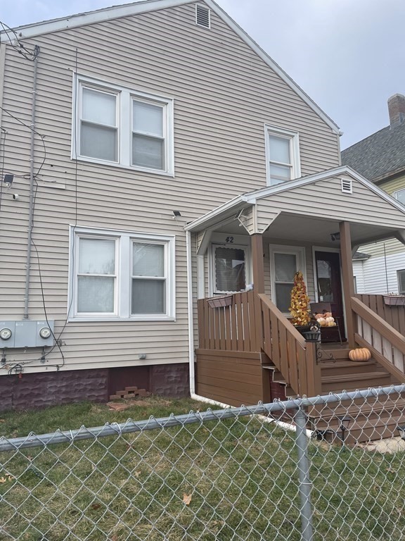 42-44 Grover Street Springfield, MA 01104 - Photo 18 of 24 a view of a house with a small yard and wooden fence
