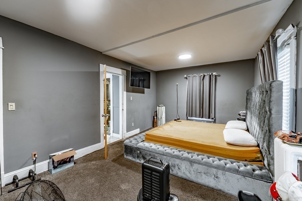 42-44 Grover Street Springfield, MA 01104 - Photo 5 of 24 a bedroom with a bed and a table