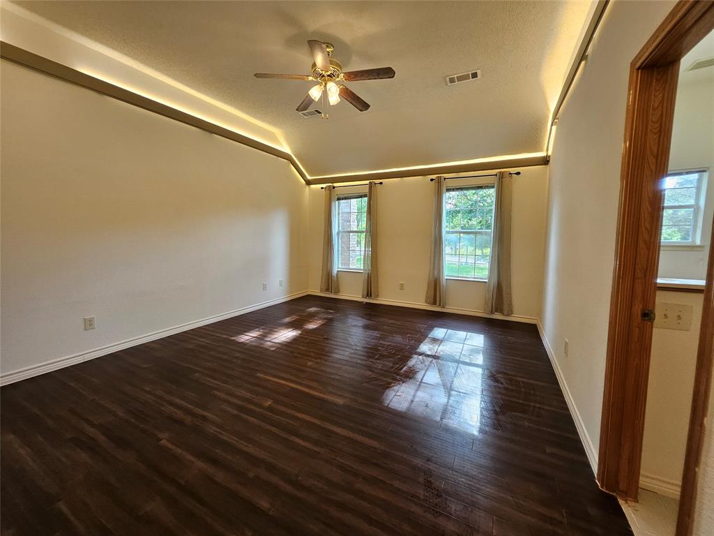 234 East Fork Road Sunnyvale, TX 75182 - Photo 10 of 32 a view of an empty room with wooden floor and a window
