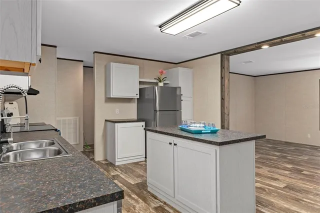 a kitchen with a sink and refrigerator