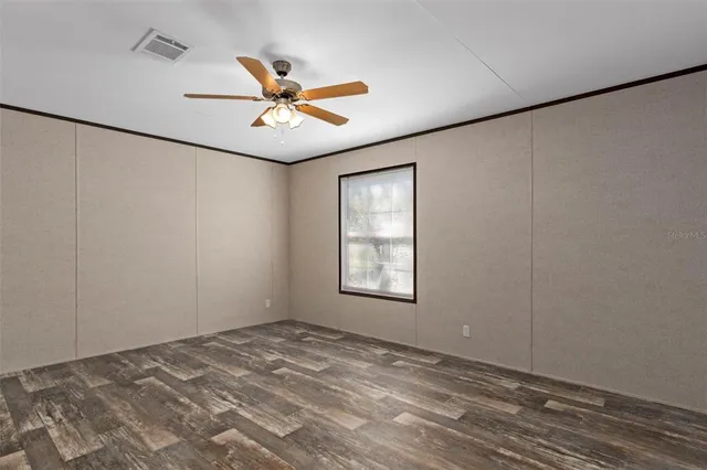 a view of a ceiling fan and a window in the room