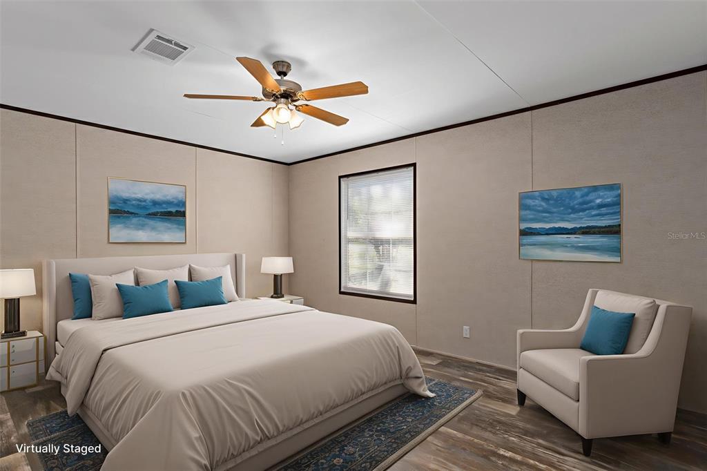 2455 East North Street Inverness, FL 34453 - Photo 19 of 27 a bedroom with a large bed and a window