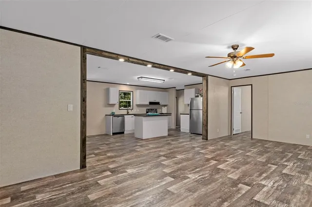 a view of a kitchen with a sink and a refrigerator