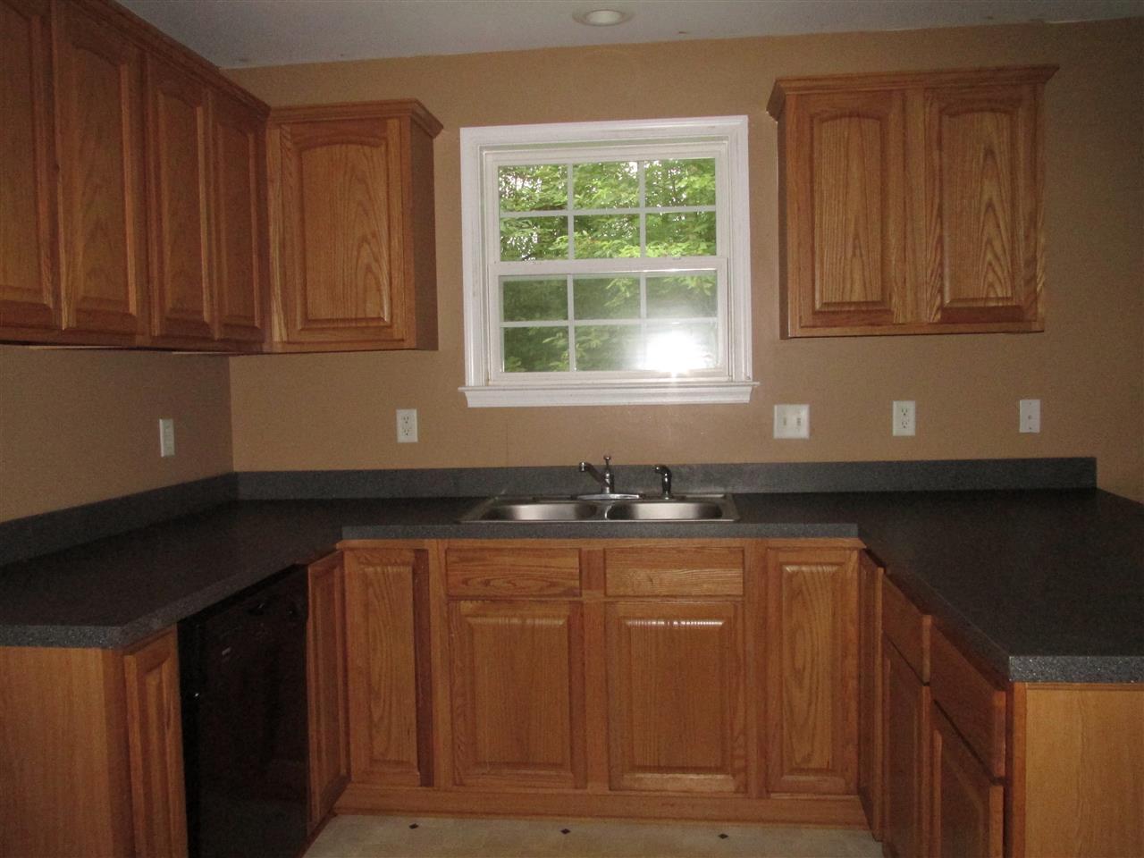 109 Fairview Road Louisa, VA 23093 - Photo 5 of 8 a kitchen with granite countertop wooden cabinets a sink and dishwasher