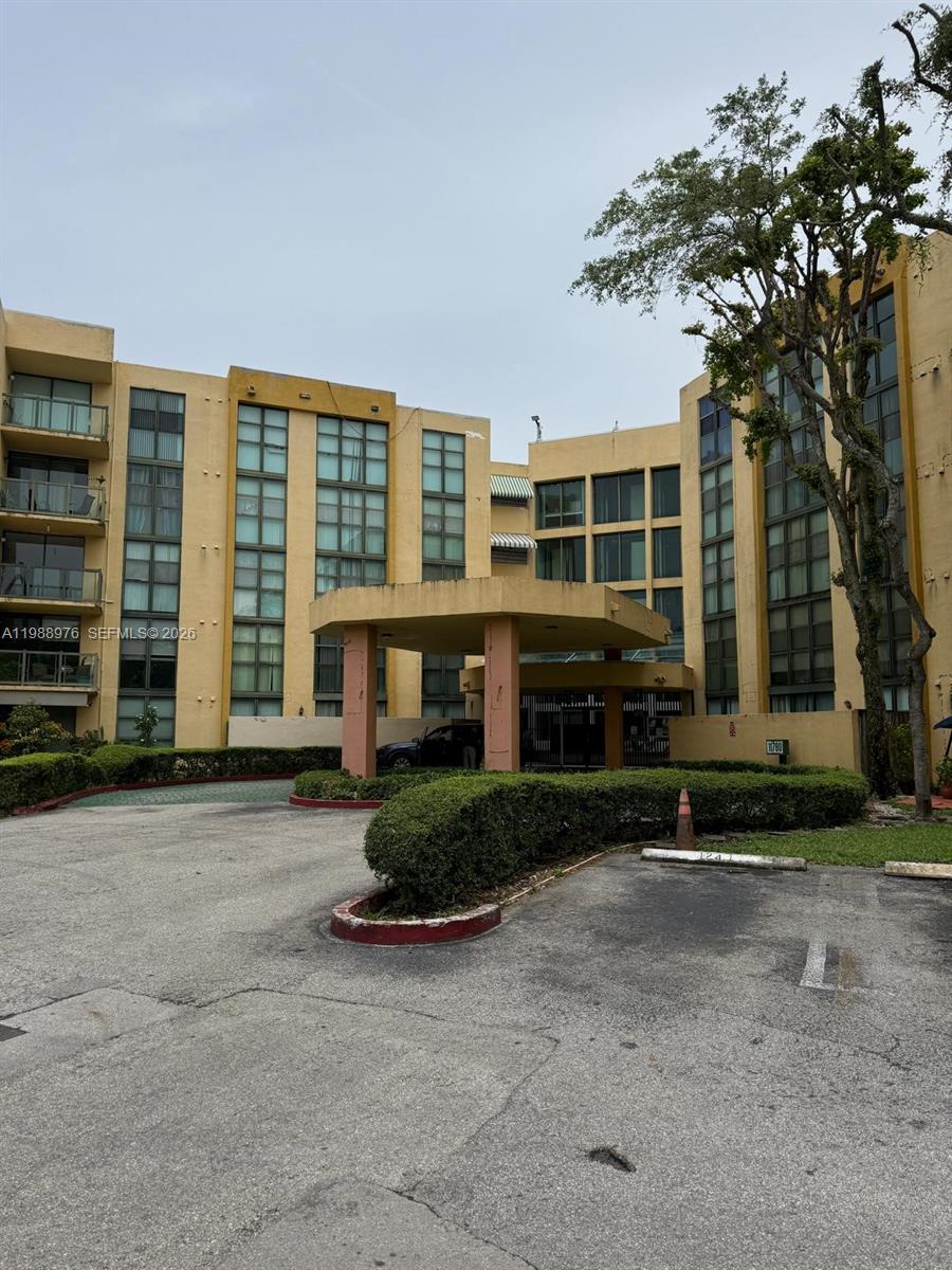 11780 Southwest 18th Street, Unit 2302 Miami, FL 33175 - Photo 1 of 15 a front view of a house with a yard