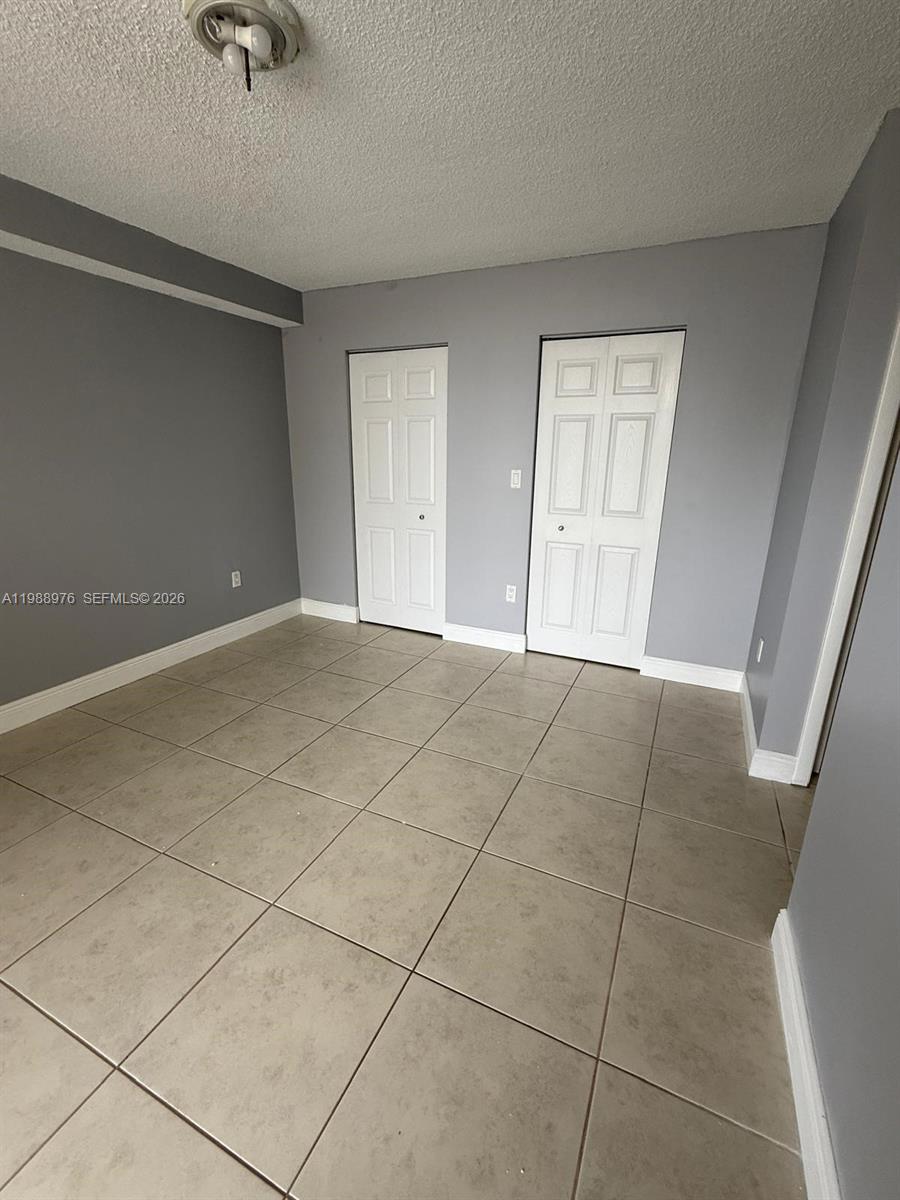 11780 Southwest 18th Street, Unit 2302 Miami, FL 33175 - Photo 12 of 15 a view of an empty room with a window