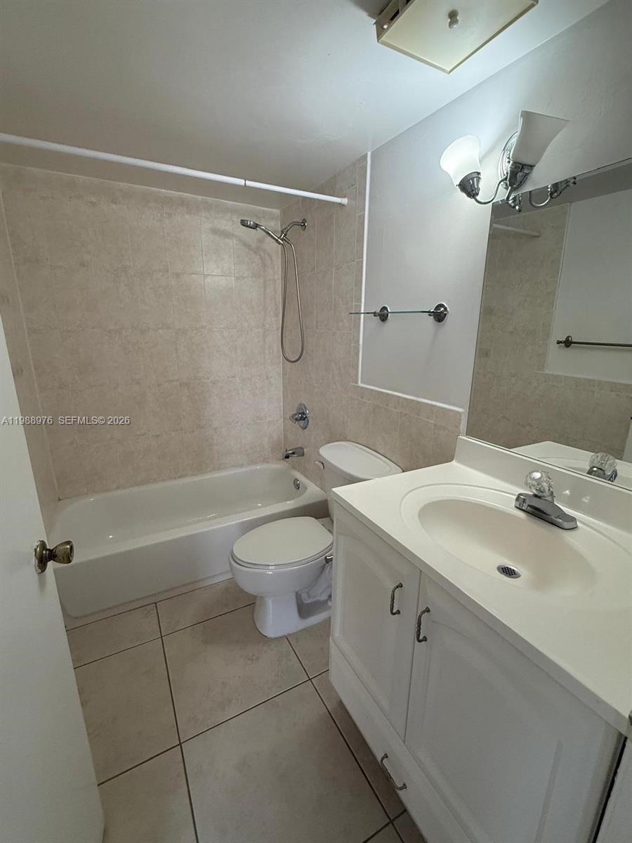 11780 Southwest 18th Street, Unit 2302 Miami, FL 33175 - Photo 13 of 15 a bathroom with a sink a toilet and shower