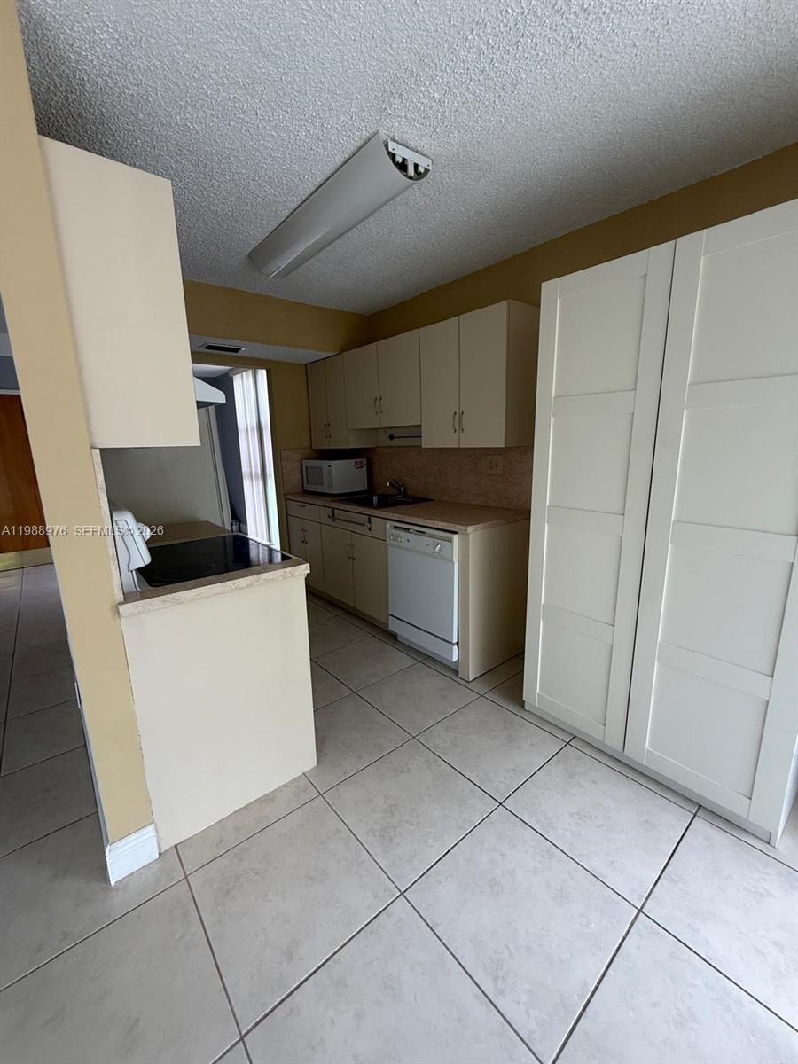 11780 Southwest 18th Street, Unit 2302 Miami, FL 33175 - Photo 15 of 15 a kitchen with stainless steel appliances a refrigerator sink and microwave