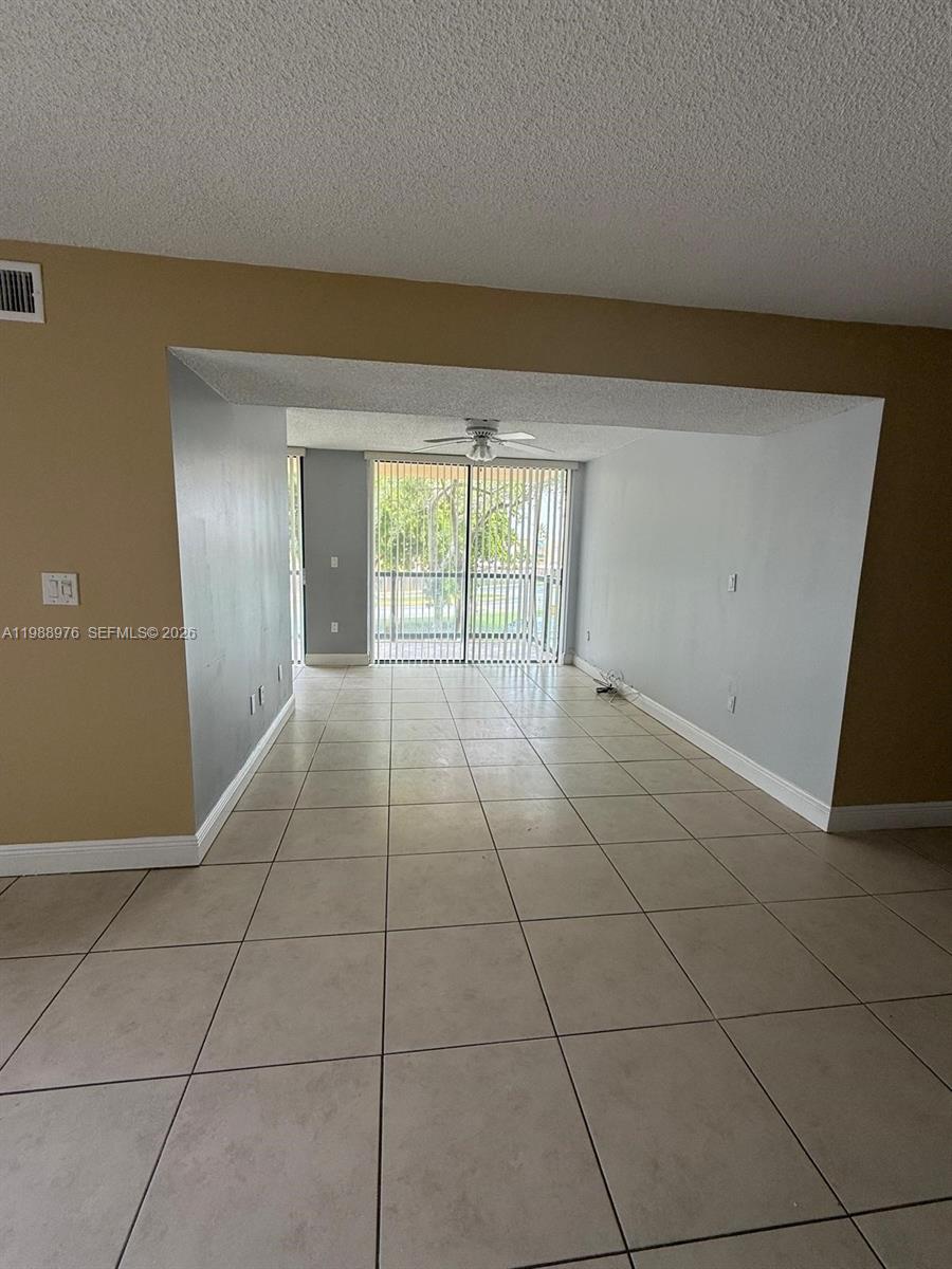 11780 Southwest 18th Street, Unit 2302 Miami, FL 33175 - Photo 2 of 15 a view of an empty room with a window