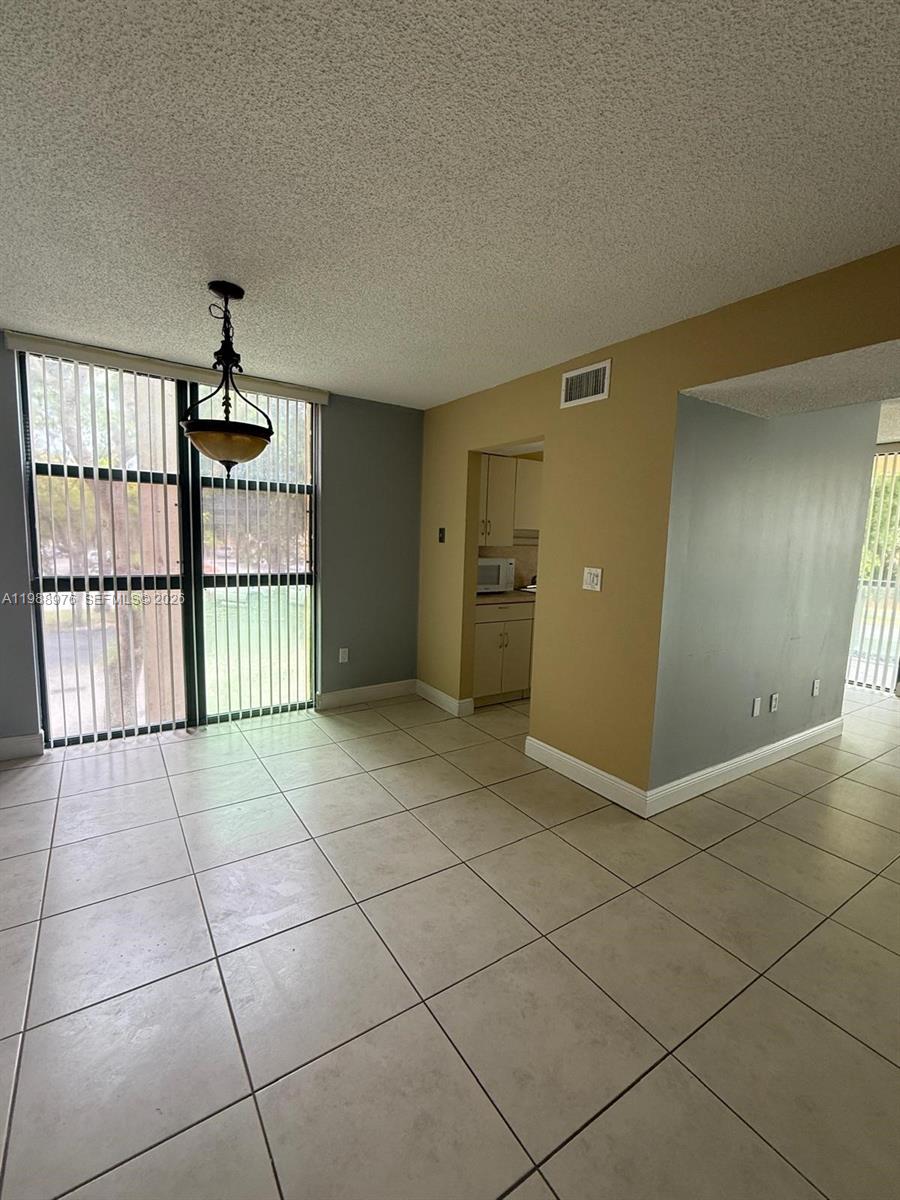 11780 Southwest 18th Street, Unit 2302 Miami, FL 33175 - Photo 3 of 15 a view of an empty room with a window
