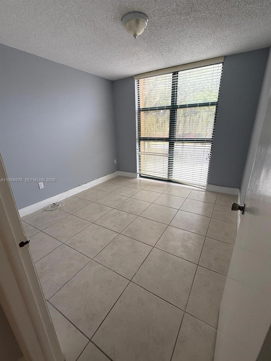11780 Southwest 18th Street, Unit 2302 Miami, FL 33175 - Photo 8 of 15 a view of an empty room with a window