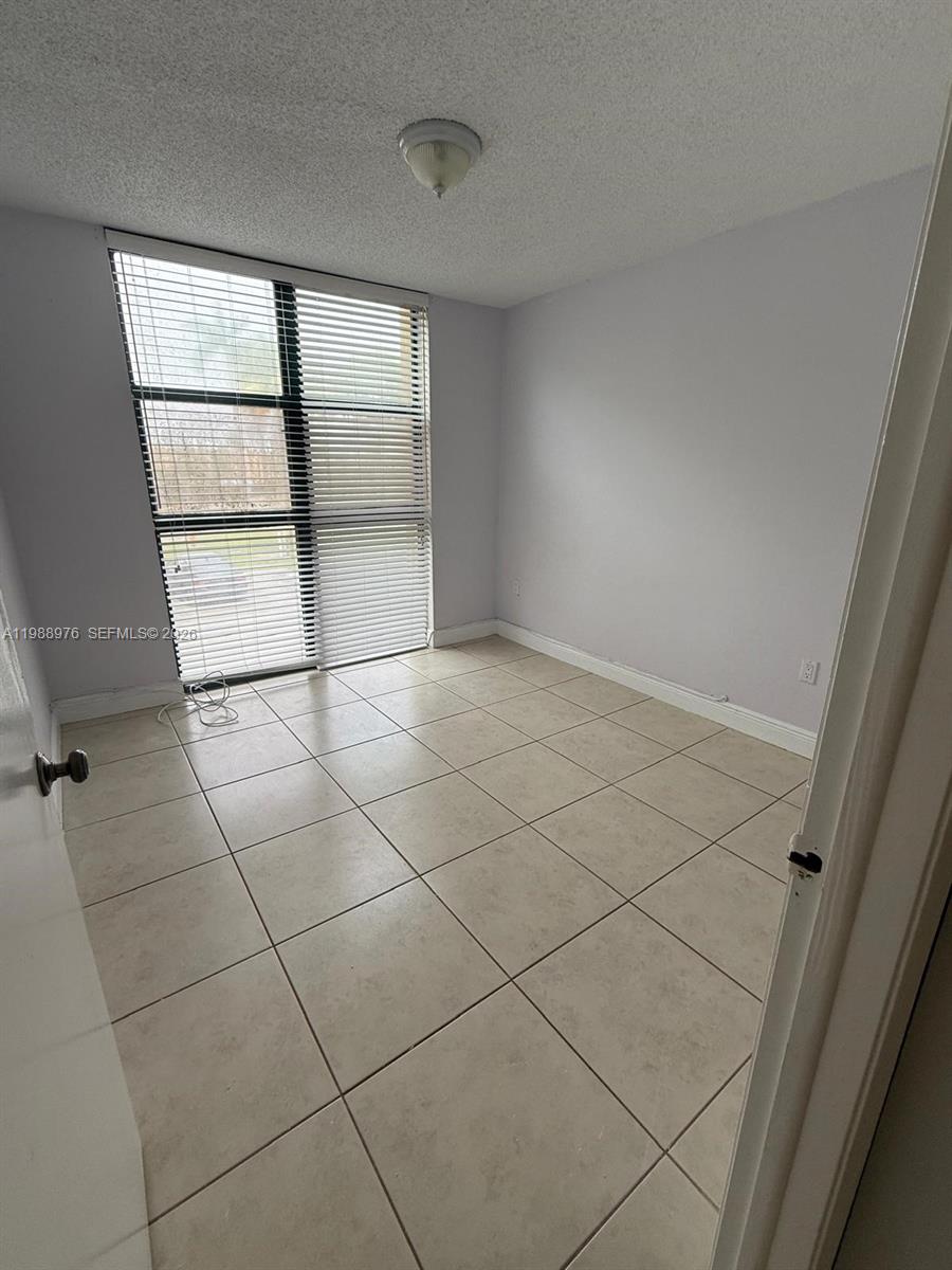 11780 Southwest 18th Street, Unit 2302 Miami, FL 33175 - Photo 9 of 15 an empty room with a window