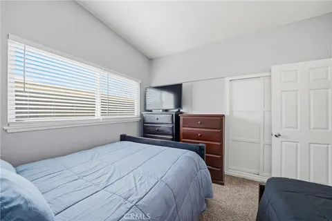 a bedroom with a bed and a television