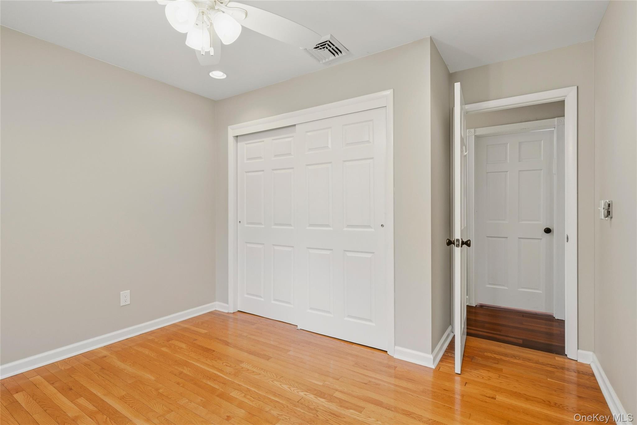 44 Sayer Road Blooming Grove, NY 10914 - Photo 18 of 39 an empty room with wooden floor closet and windows