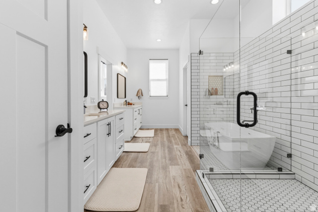 886 North 300th East Spring City, UT 84662 - Photo 28 of 40 Full bath featuring double vanity, light wood-type flooring, a soaking tub, a shower stall, and recessed lighting