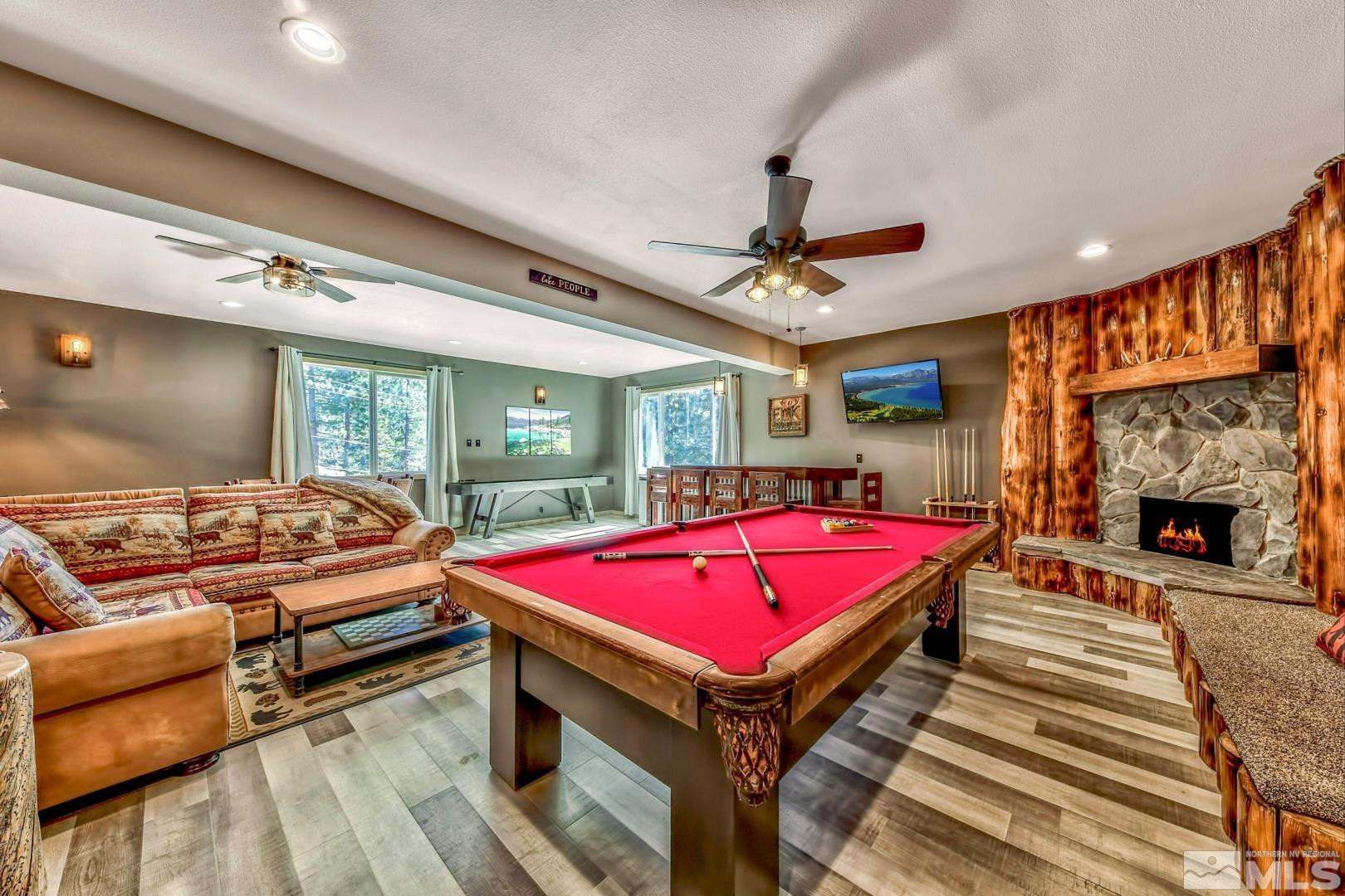 256 North Benjamin Drive Stateline, NV 89449 - Photo 22 of 36 a living room with a table tennis pool table and a fireplace