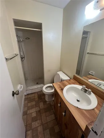 a bathroom with a sink toilet and shower