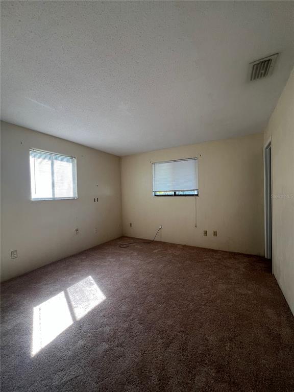 638 LPGA Boulevard, Unit A Daytona Beach, FL 32117 - Photo 5 of 9 an empty room with a empty space and windows