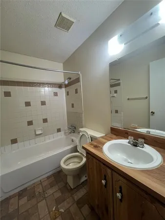 a bathroom with a sink a toilet a mirror a bathtub and shower