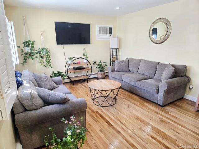 6 East Kissimee Road Lindenhurst, NY 11757 - Photo 3 of 15 a living room with furniture and a potted plant