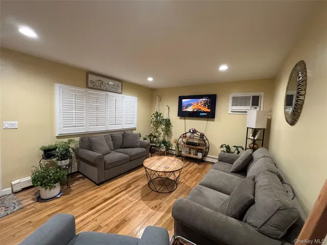 a living room with furniture kitchen view and a window