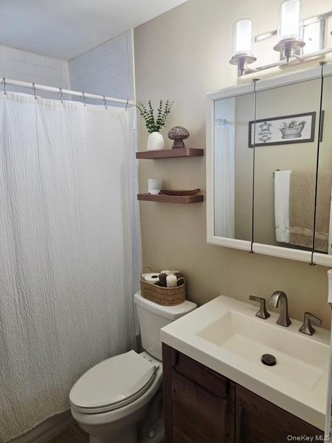 6 East Kissimee Road Lindenhurst, NY 11757 - Photo 6 of 15 a bathroom with a sink vanity mirror and toilet