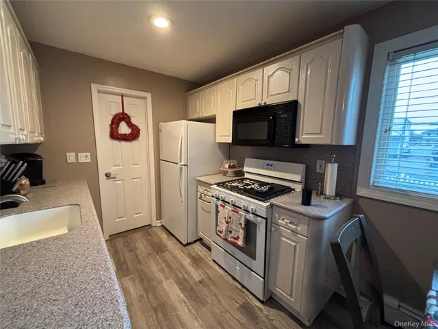 a kitchen with a stove a refrigerator and a sink
