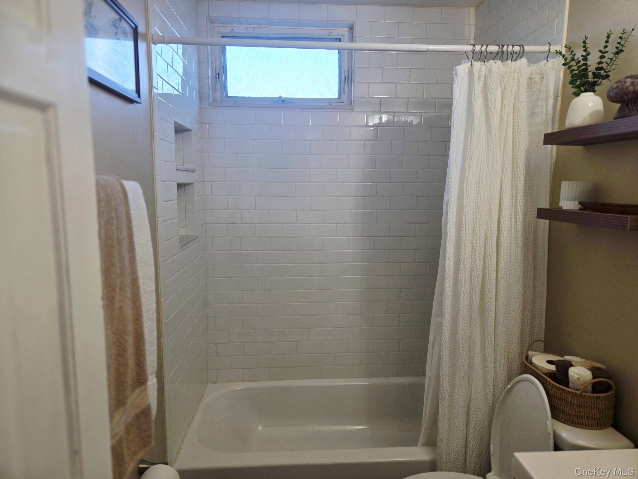 6 East Kissimee Road Lindenhurst, NY 11757 - Photo 7 of 15 a bathroom with a shower and a tub