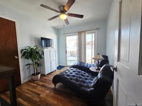 a bedroom with a bed chandelier and a window