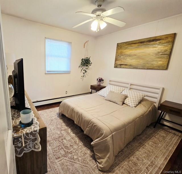 6 East Kissimee Road Lindenhurst, NY 11757 - Photo 9 of 15 a bedroom with a bed and a chandelier