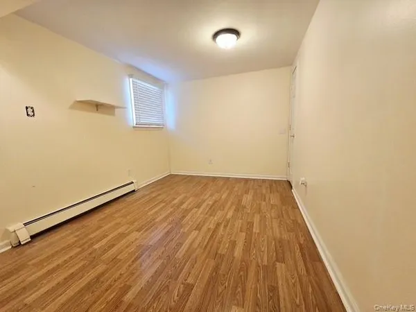 a view of a room with wooden floor