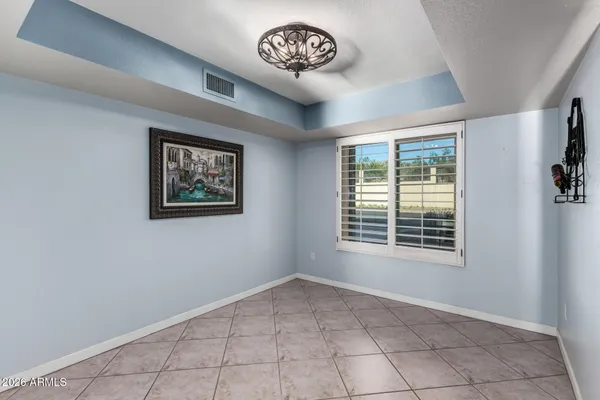 a view of an empty room with a fireplace and window