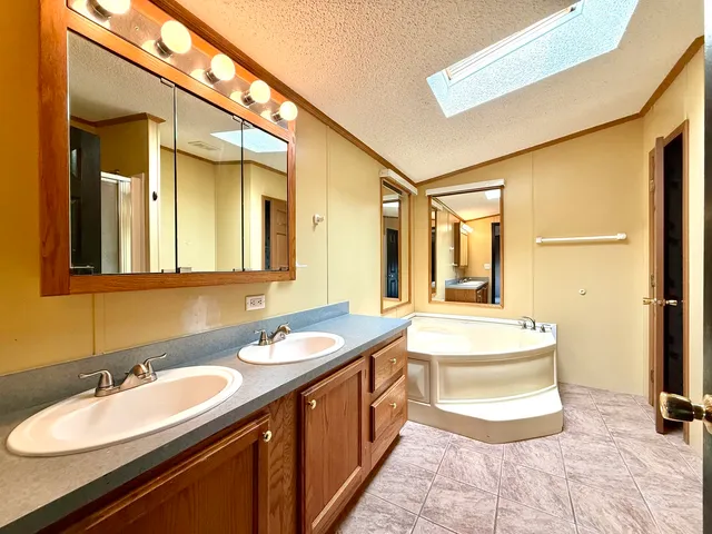 a spacious bathroom with a double vanity sink mirror and double