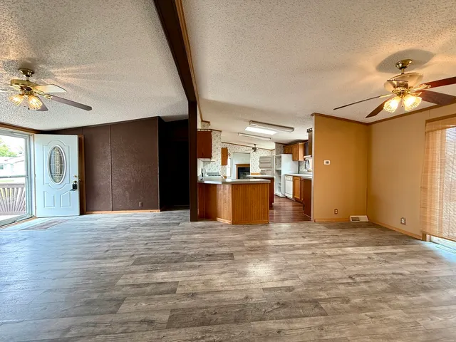 a view of a kitchen with a sink and a refrigerator