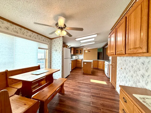 a living room with stainless steel appliances furniture and a large window