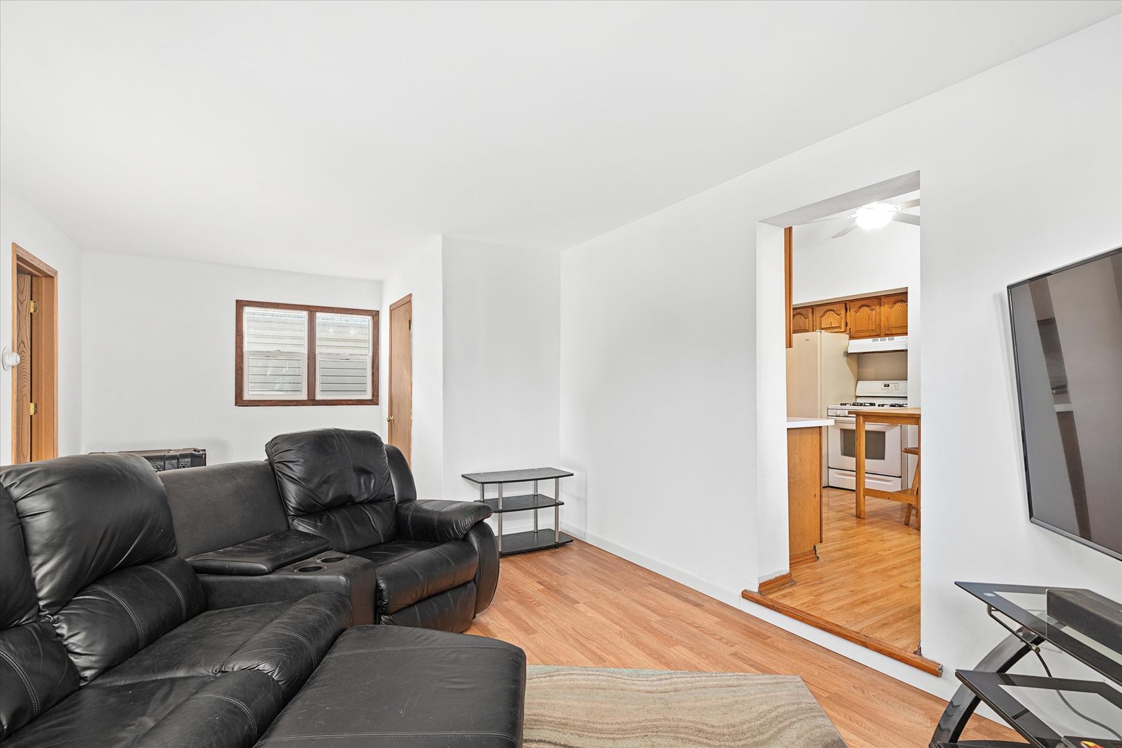 6236 Washington Street Chicago Ridge, IL 60415 - Photo 13 of 32 a living room with furniture a flat screen tv and a window